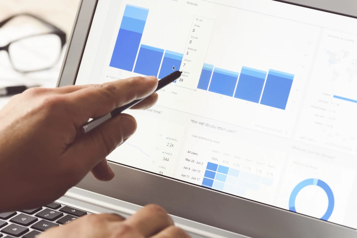 Reviewing analytics on a laptop during a strategy session